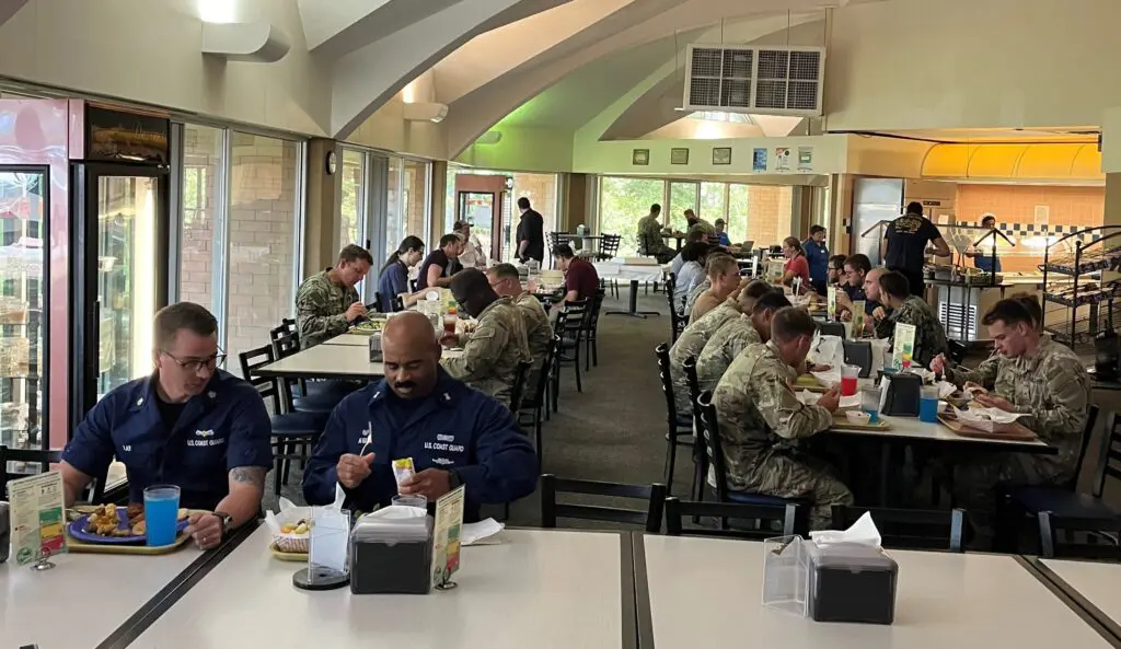 Group of sailors eating at a cafeteria