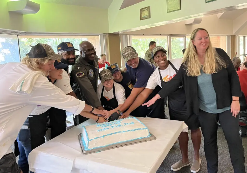 people cutting a cake