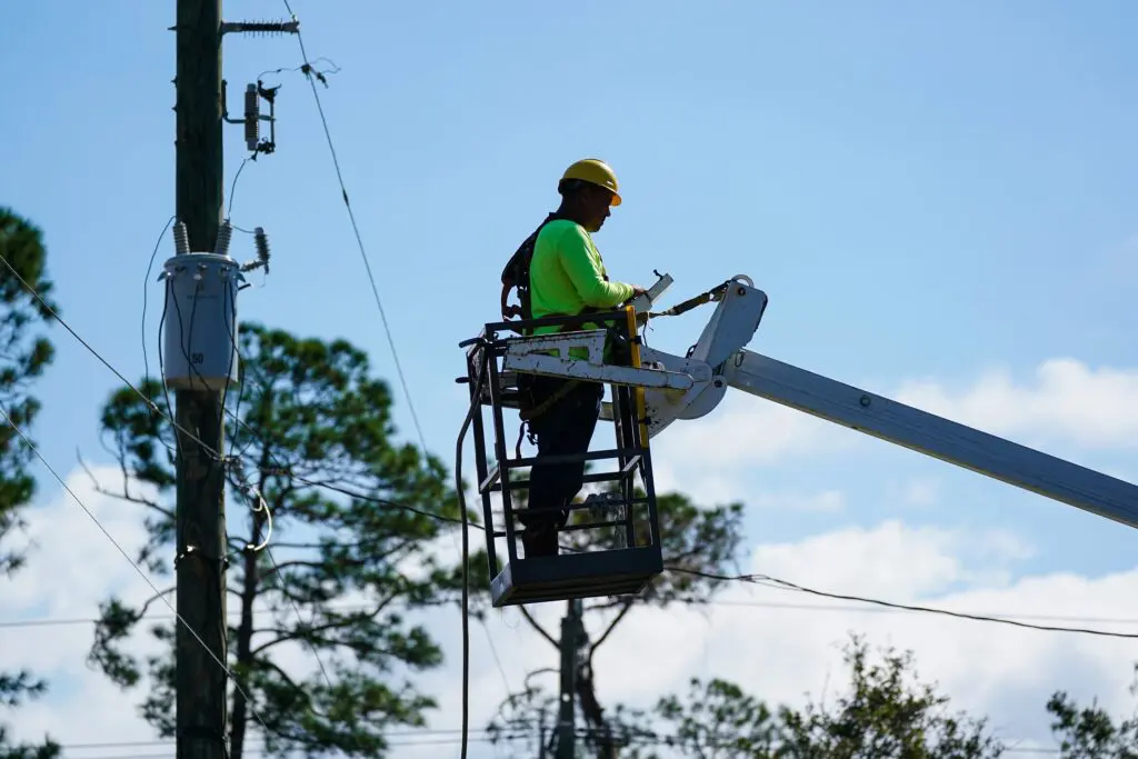 Xfinity contractor working in a bucket truck to restore connectivity after a storm.