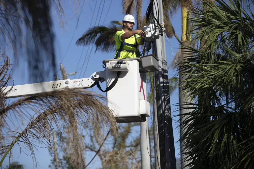 An Xfinity technician works to repair a line following damage caused by the hurricane.