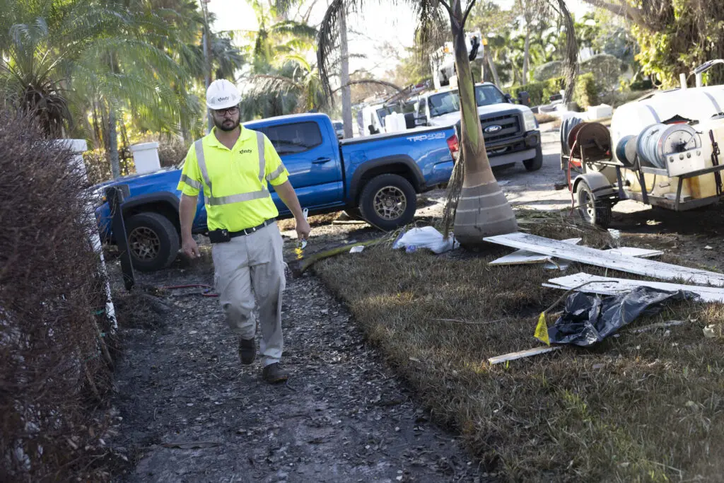 Comcast field technicians work to restore information services to people who lost service due to hurricane damage.