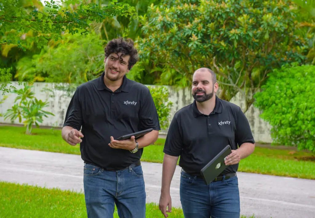 two men with something in their hands walking on the street