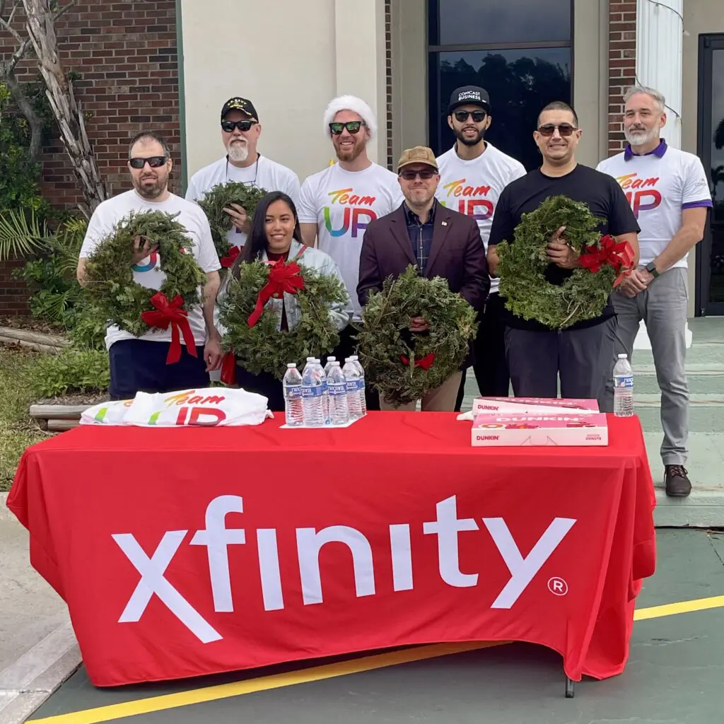 people posing for a picture with wreaths in their hands