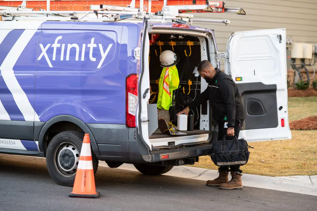 Xfinity technician getting tools from his van