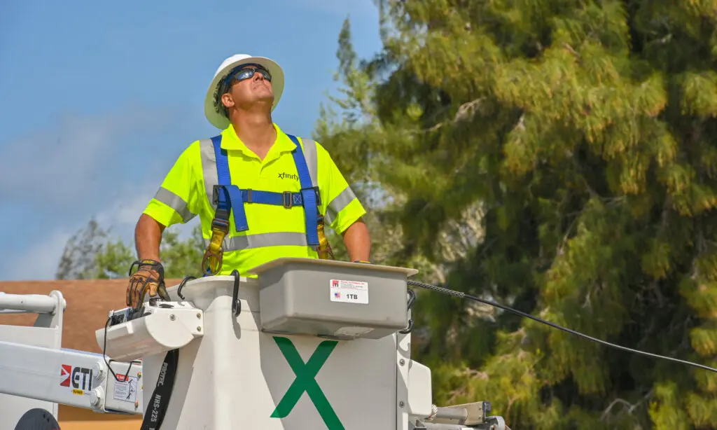 Comcast technician works from a bucket truck during network installation.