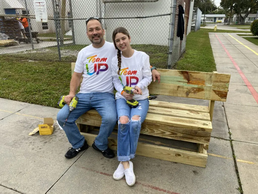 The Singers sit on their newly built bench.