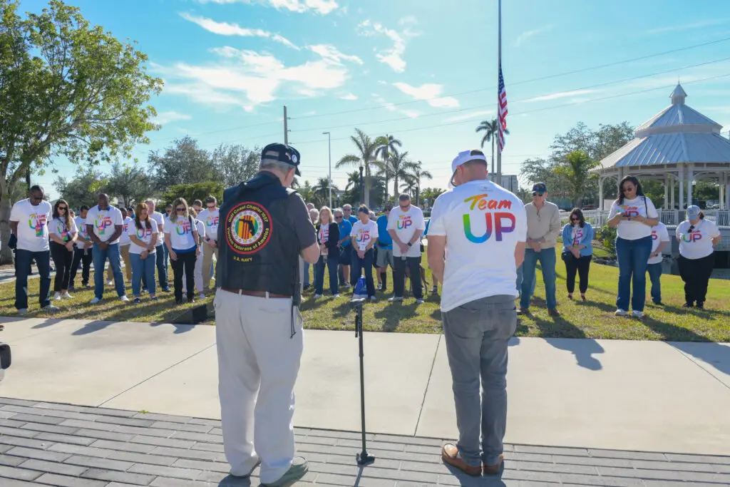 people hold minute of silence at a park