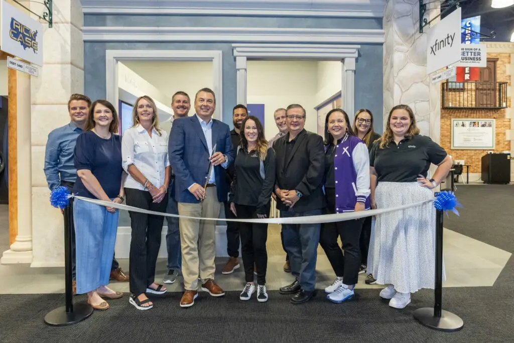 The Comcast team assembles for a ribbon cutting at the Xfinity store in JA Biztown to celebrate a Comcast investment in youth entrepreneurship.