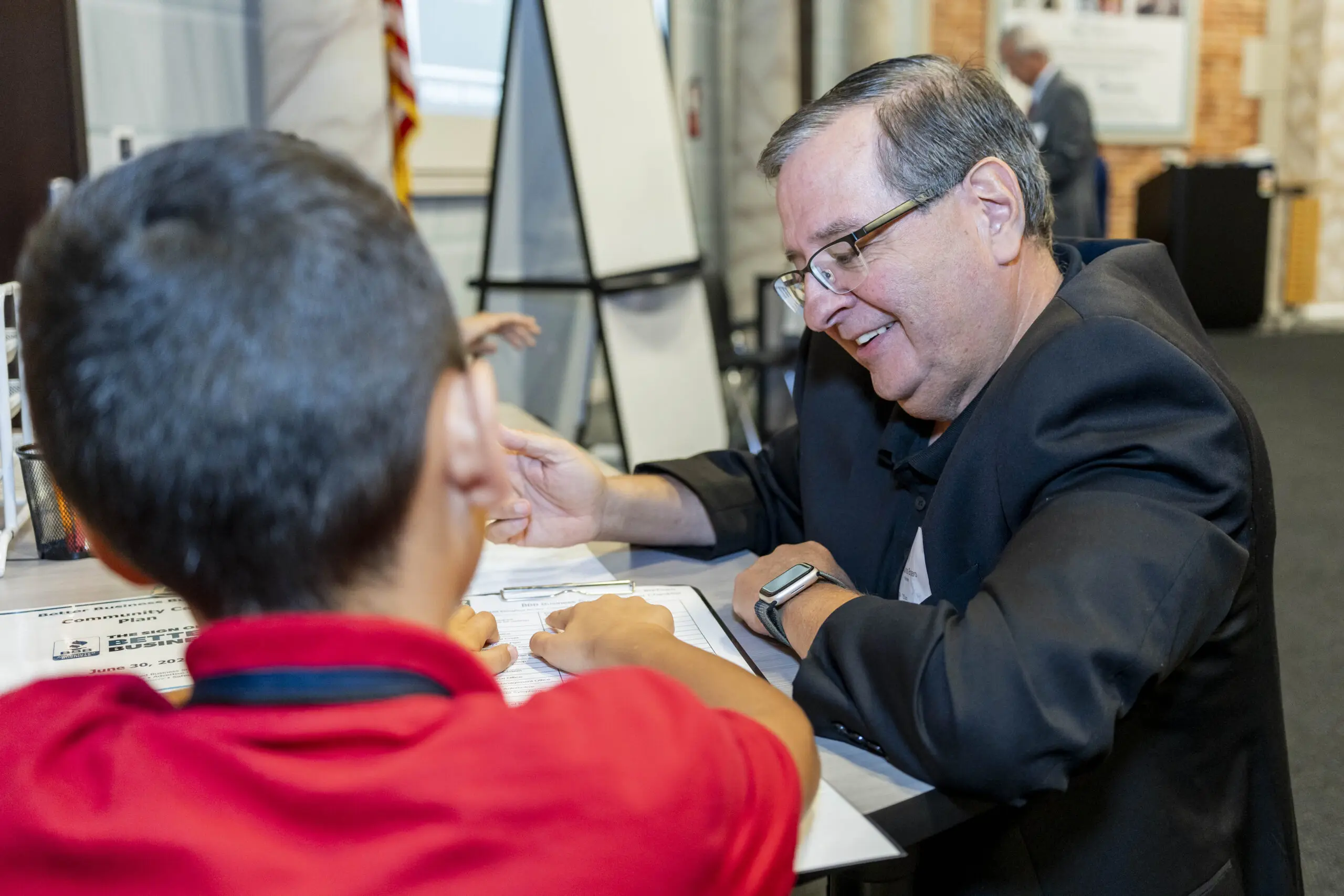 Comcast leadership works with students at JA Biztown.