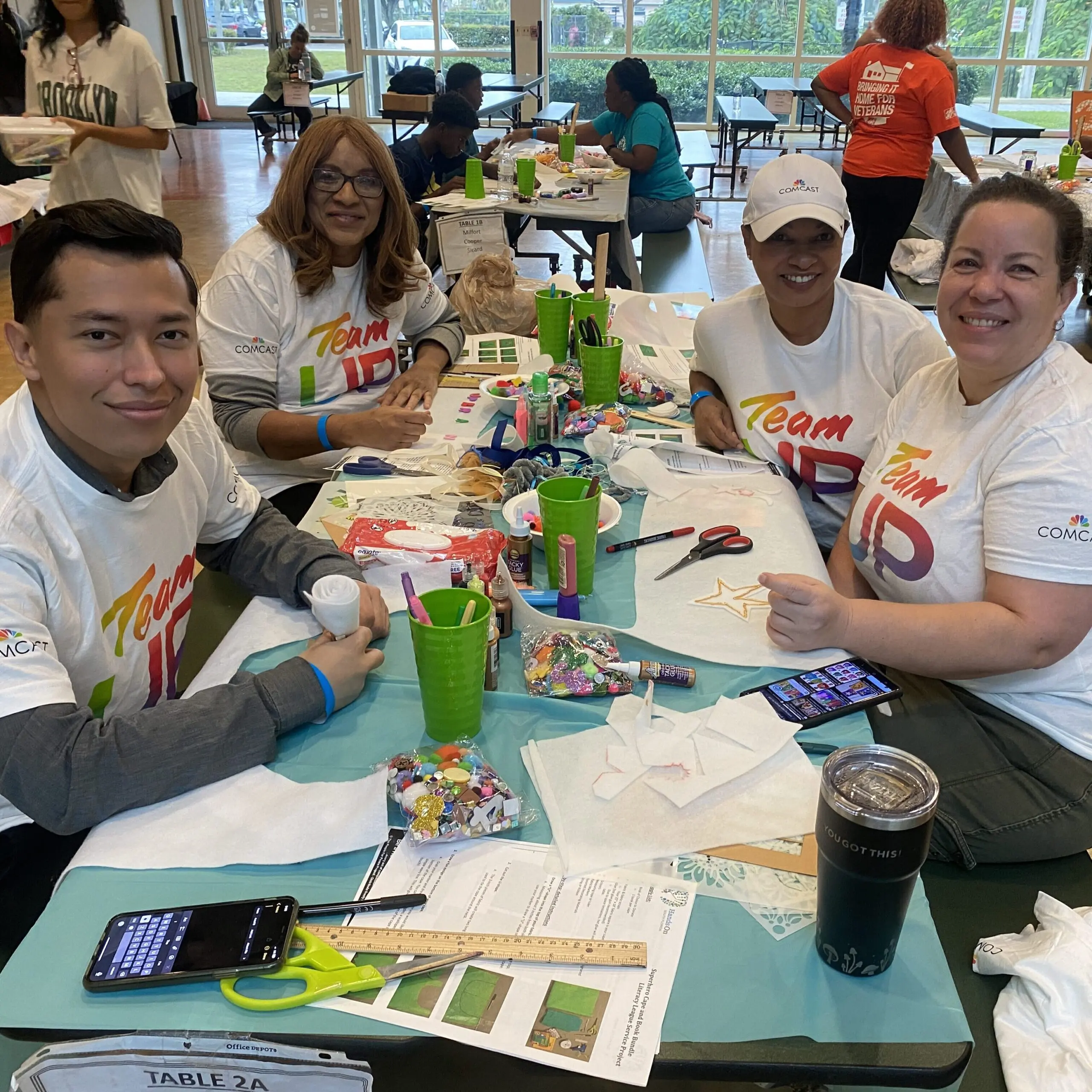 Comcast volunteers package books for students