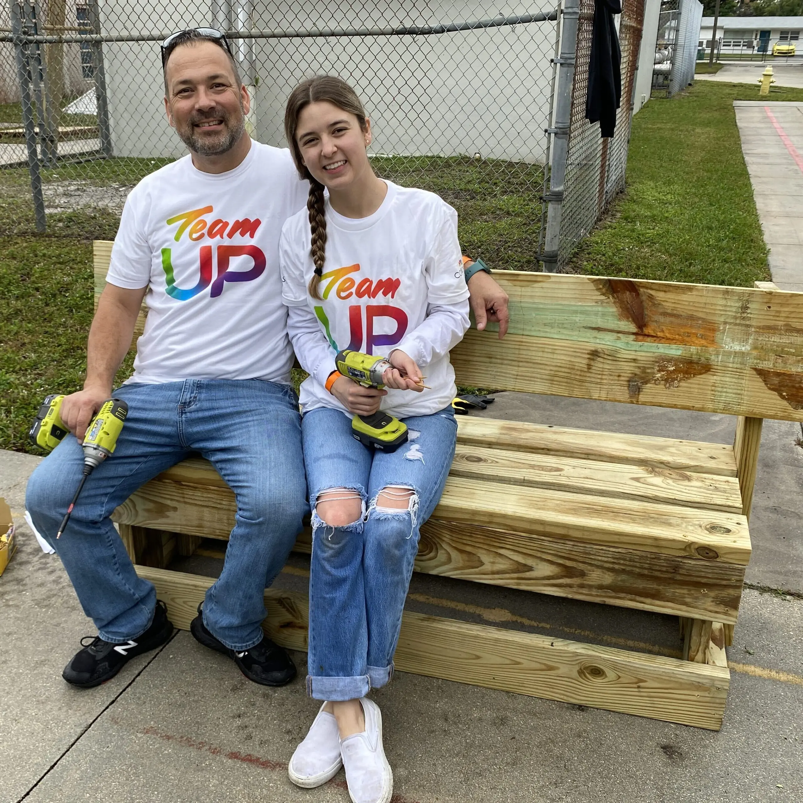 Comcast volunteers build a bench