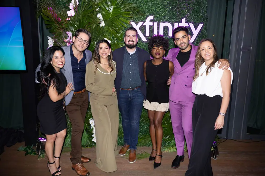 Seven people posing for a picture