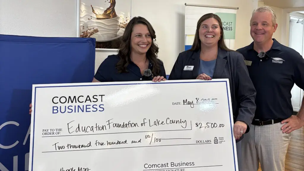 Allison Penn of Comcast presents the Education Foundation of Lake County with a check.