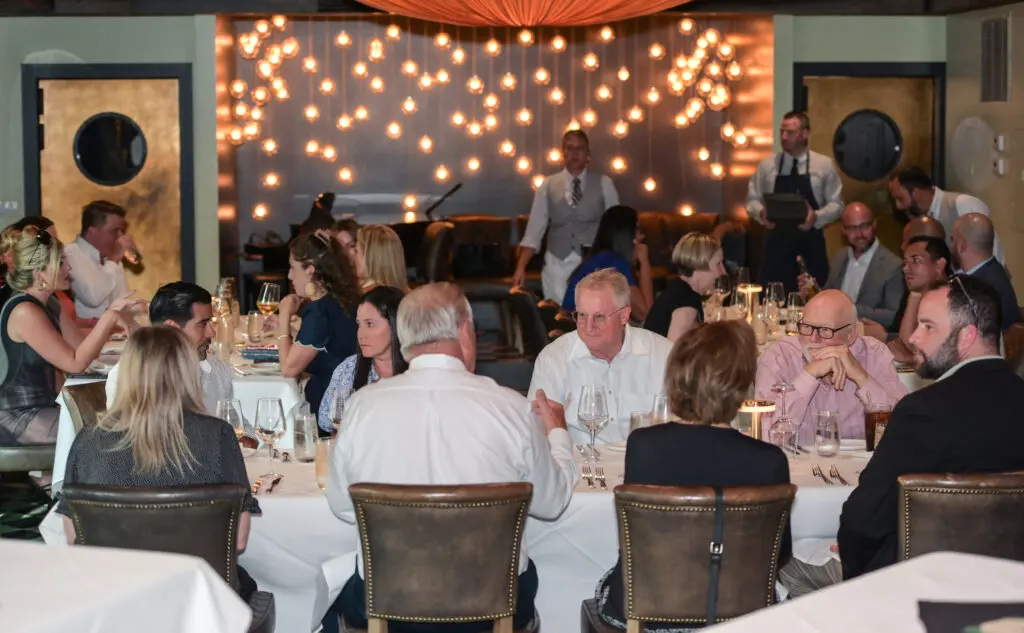 people at an event sitting in tables