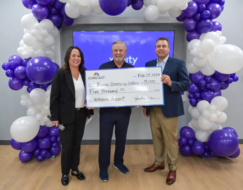people holding a donation check