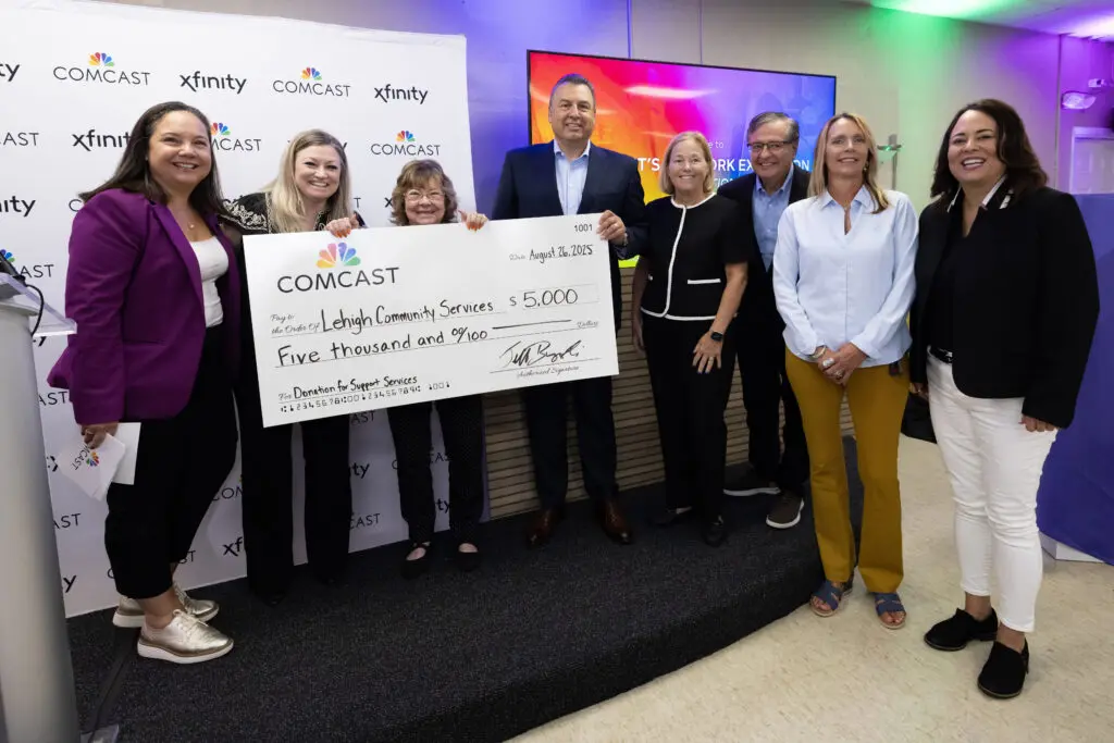 people posing with a big check