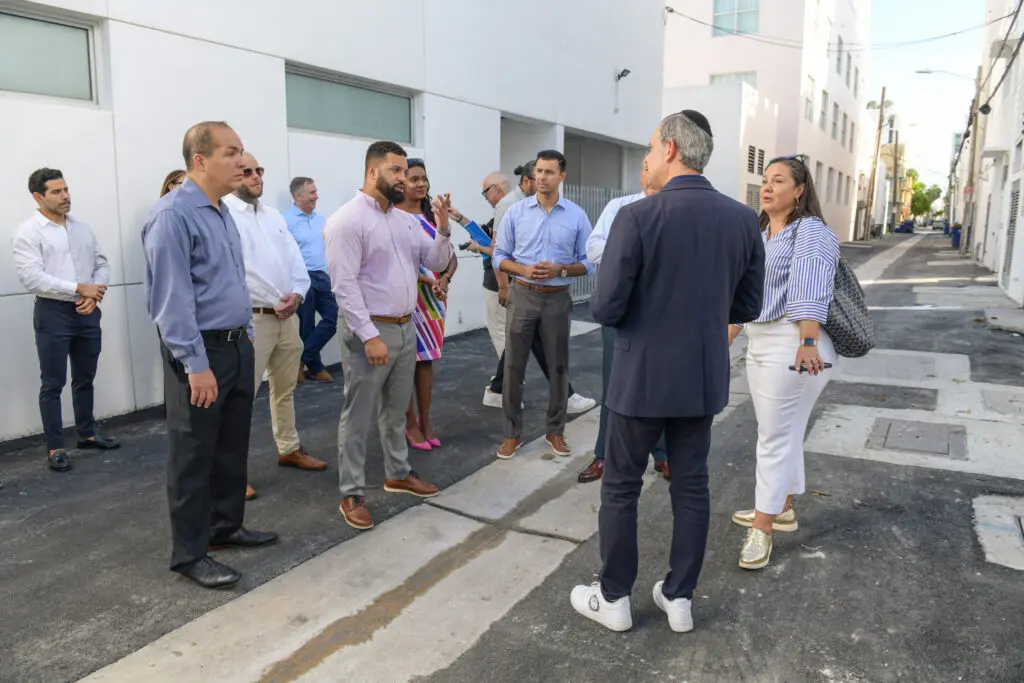 group of people in an alleyway talking
