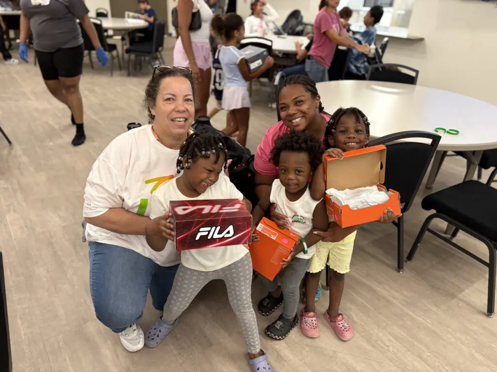 Comcast volunteers at shoe distribution