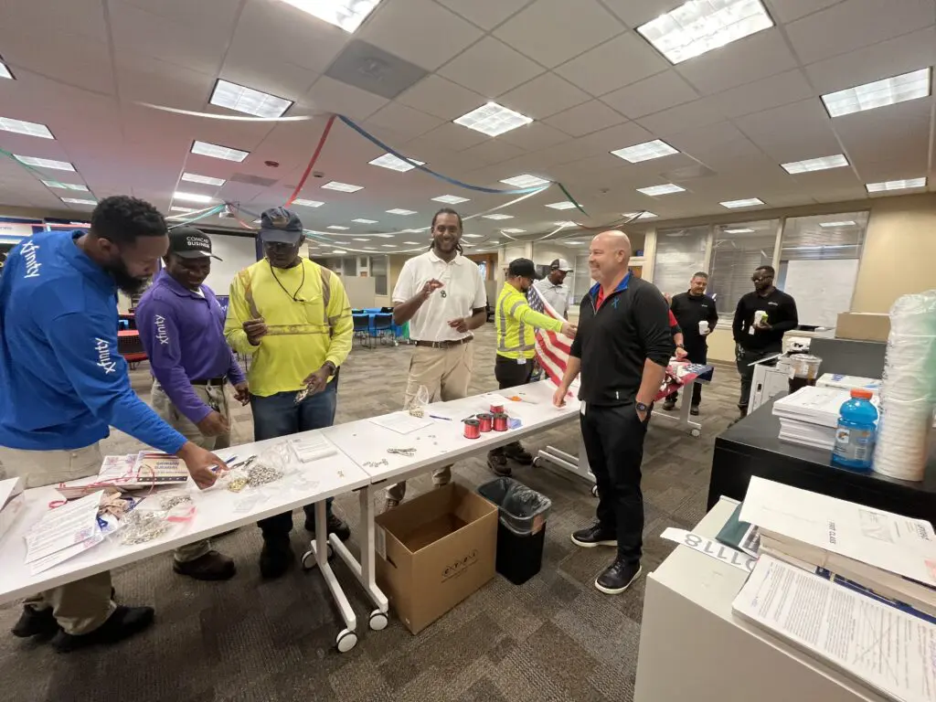 people at an event standing around a table