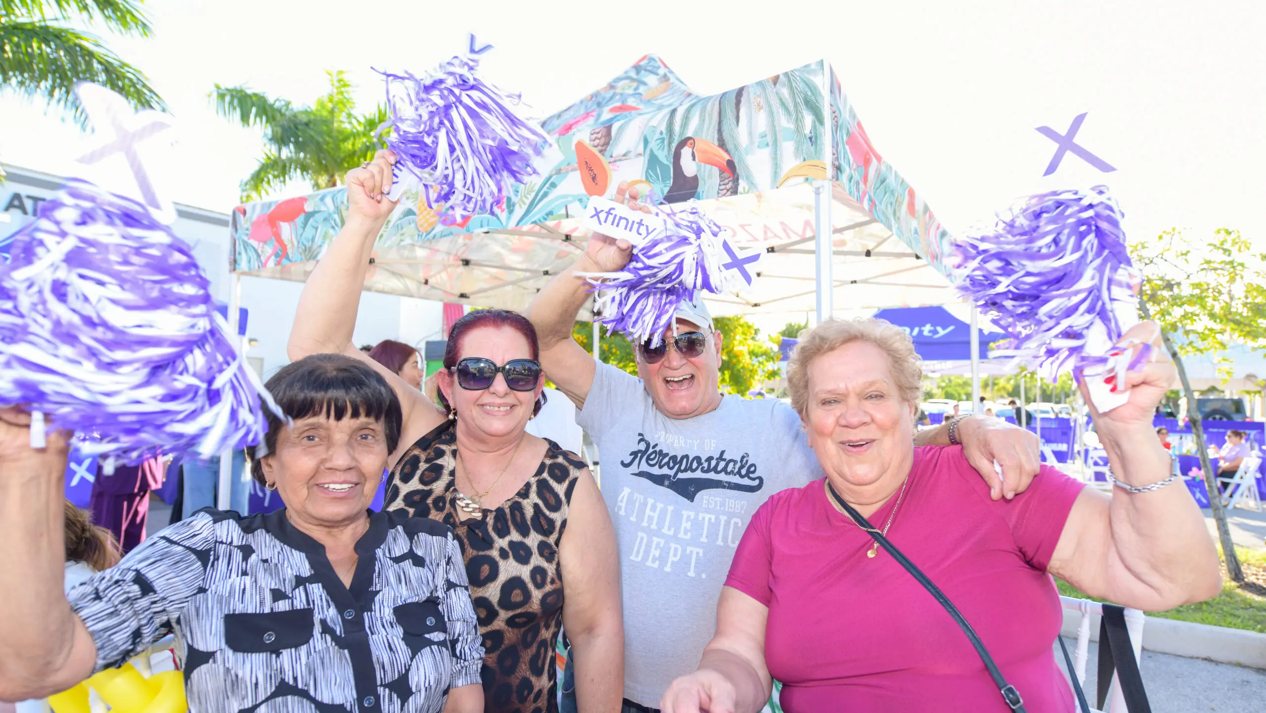 four people smiling and posing for a picture at a community event

