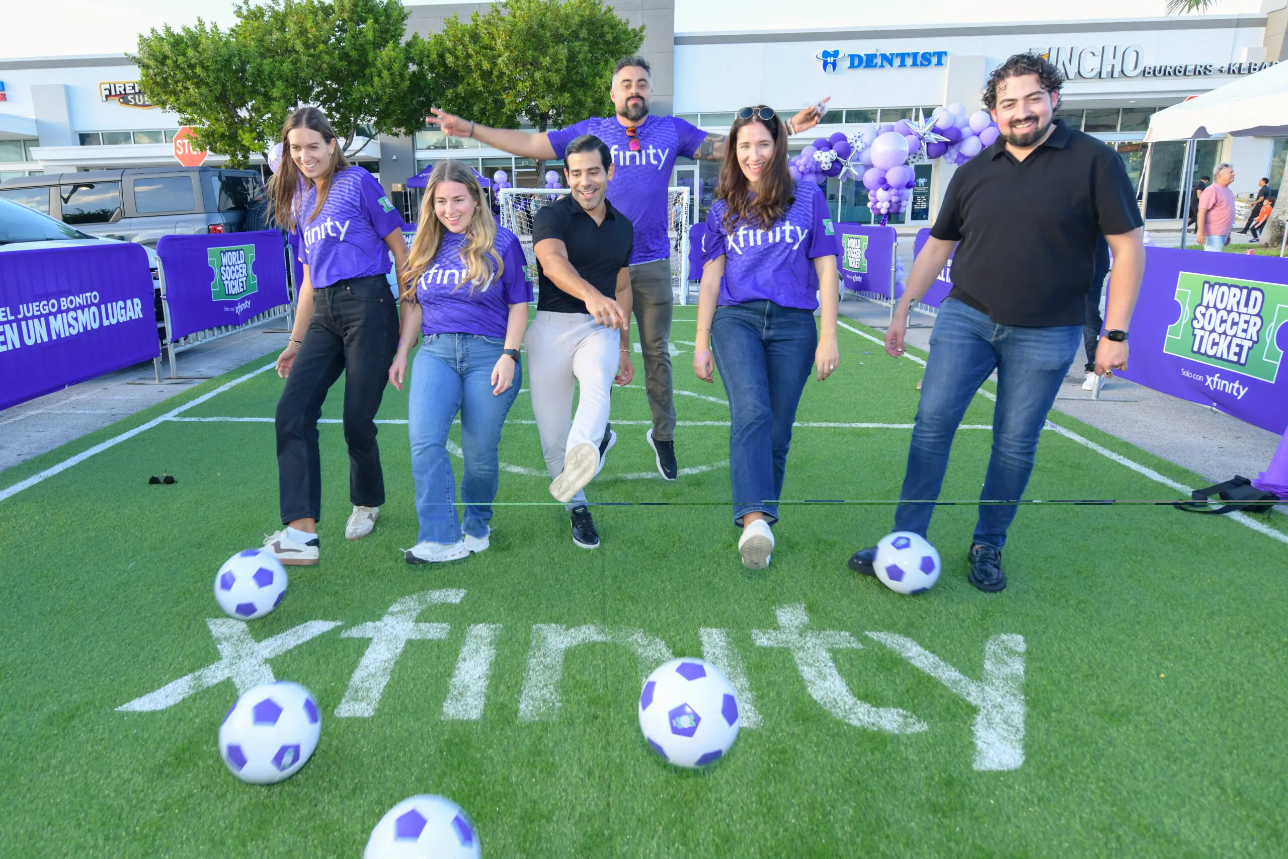 group of people kicking soccer balls