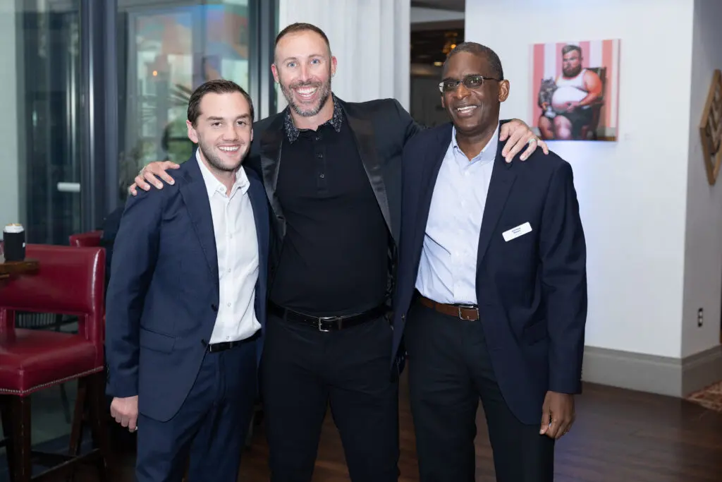 Attendees smile for a photo.