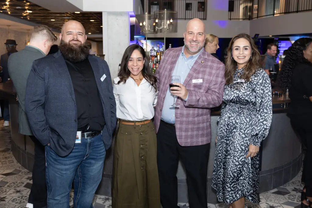 Attendees smile for a photo.