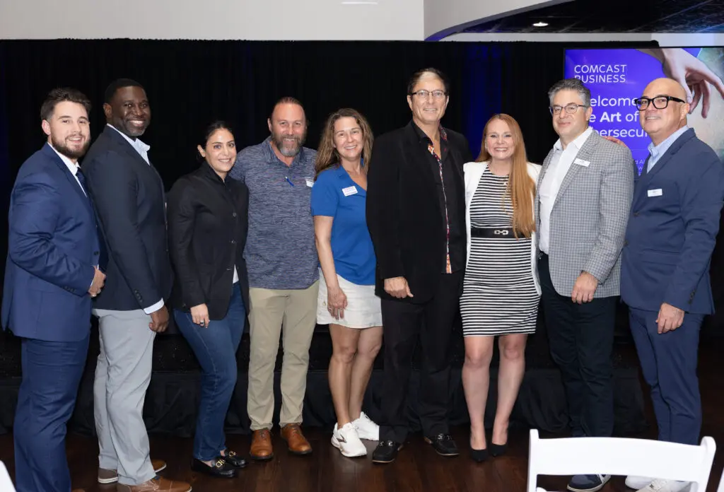 Attendees smile for a photo.