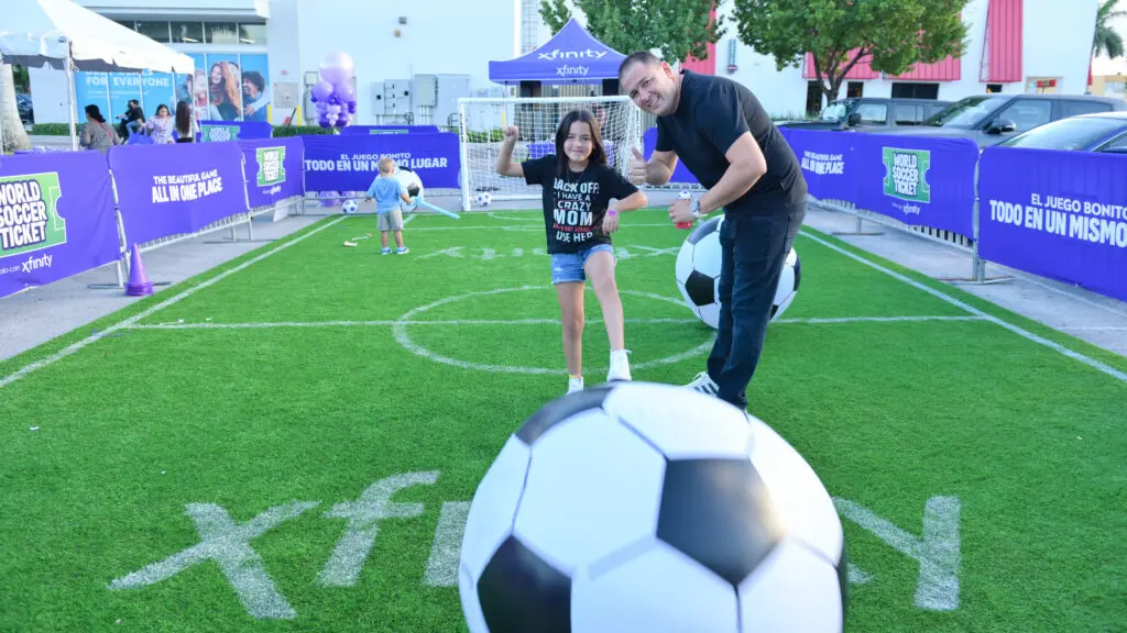 Dad and daughter playing soccer at a festival