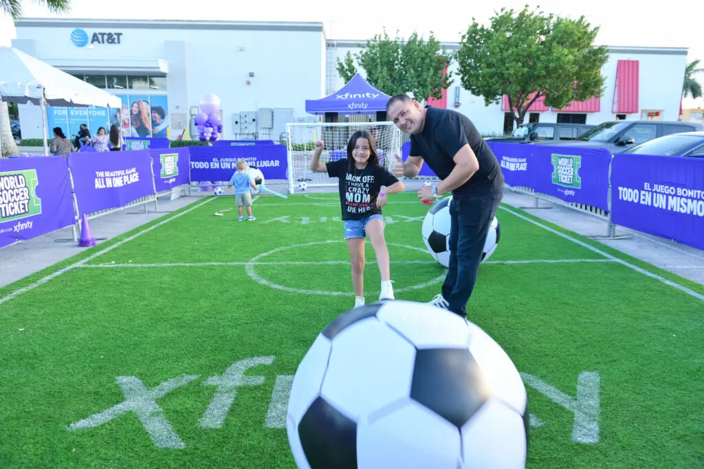 Dad and daughter at a mini soccer field