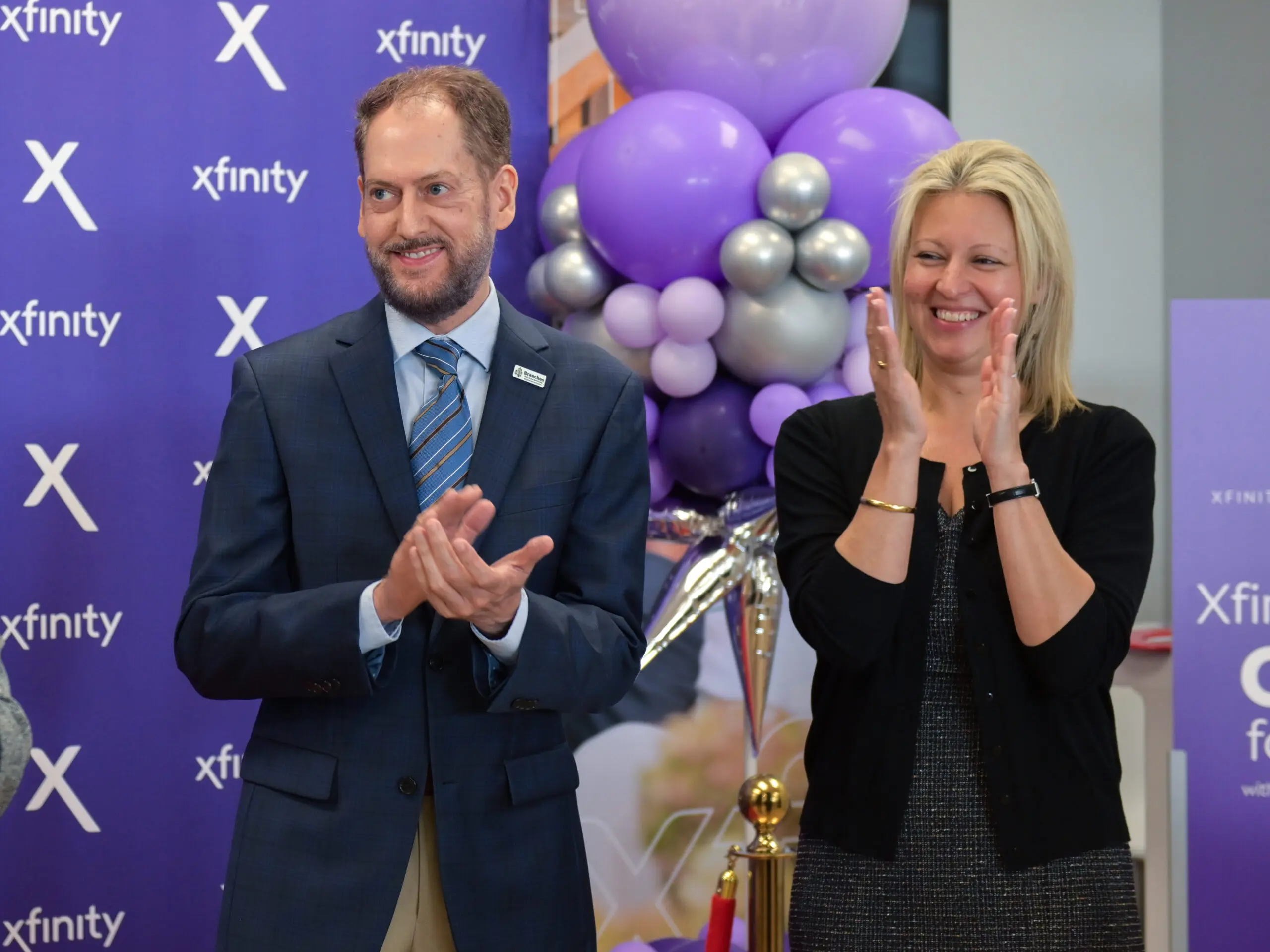 Man smiling and woman clapping