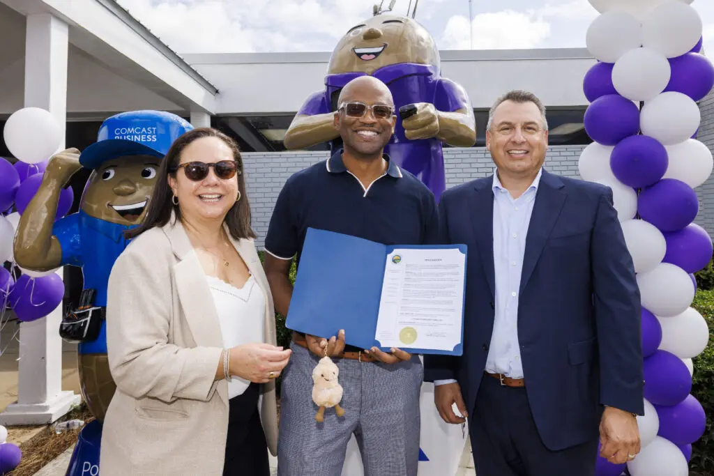 Houston County Commissioner Curtis Harvey presents Comcast with a proclamation declaring it "Peanuts Around Town Day" to celebrate the new peanut sculptures in Dothan, AL on Wednesday, Oct. 8, 2025. These new peanut sculptures join more than 100 others as part of Dothan’s iconic “Peanuts Around Town” public art project.