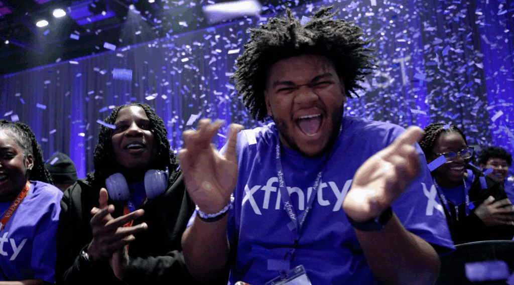 Students clapping and celebrating as confetti falls down