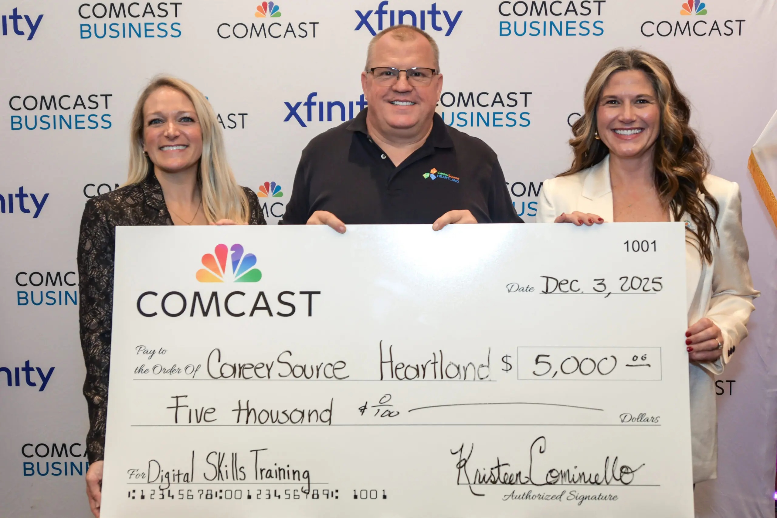 Man and two women holding a big check in Okeechobee County.
