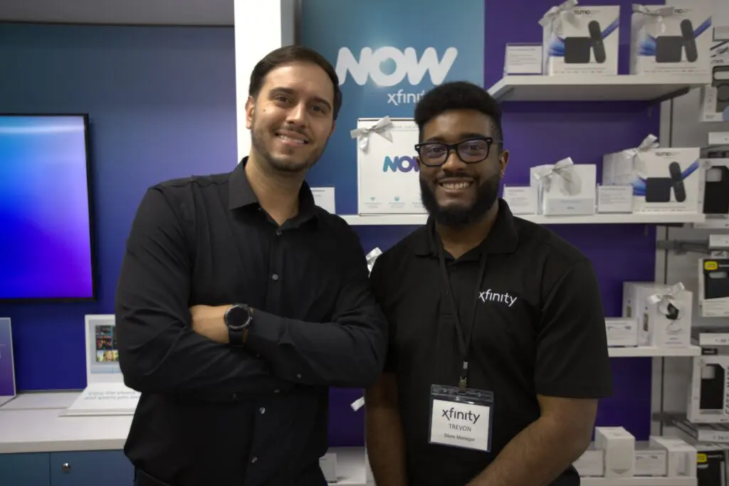 Xfinity team members inside the new Delray Beach tech hub showcasing latest internet and mobile products on display.
