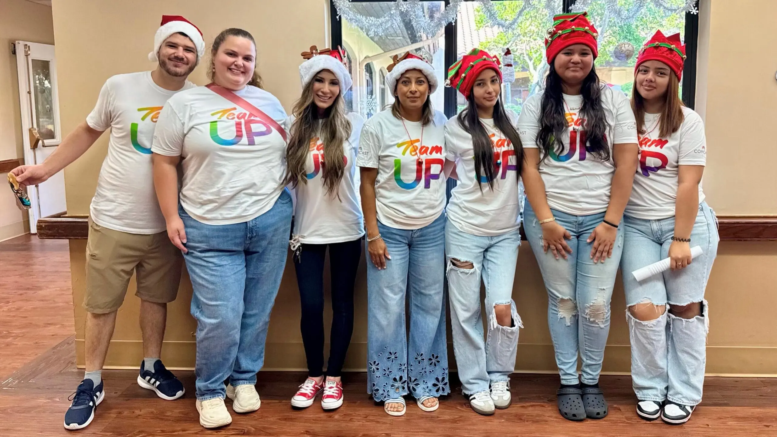 Comcast volunteers posed and smiling at a nursing home.