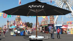 A large sun umbrella displaying the Xfinity logo.