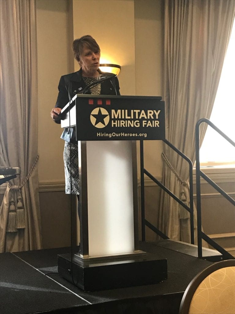 Senior Vice President of Military and Veterans Affairs for Comcast, Brigadier General (Ret.) Carol Eggert onstage at a military hiring fair.