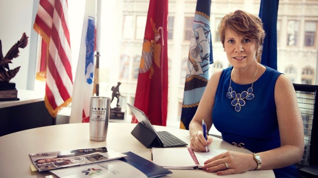 Senior Vice President of Military and Veterans Affairs for Comcast, Brigadier General (Ret.) Carol Eggert writes on a notepad.