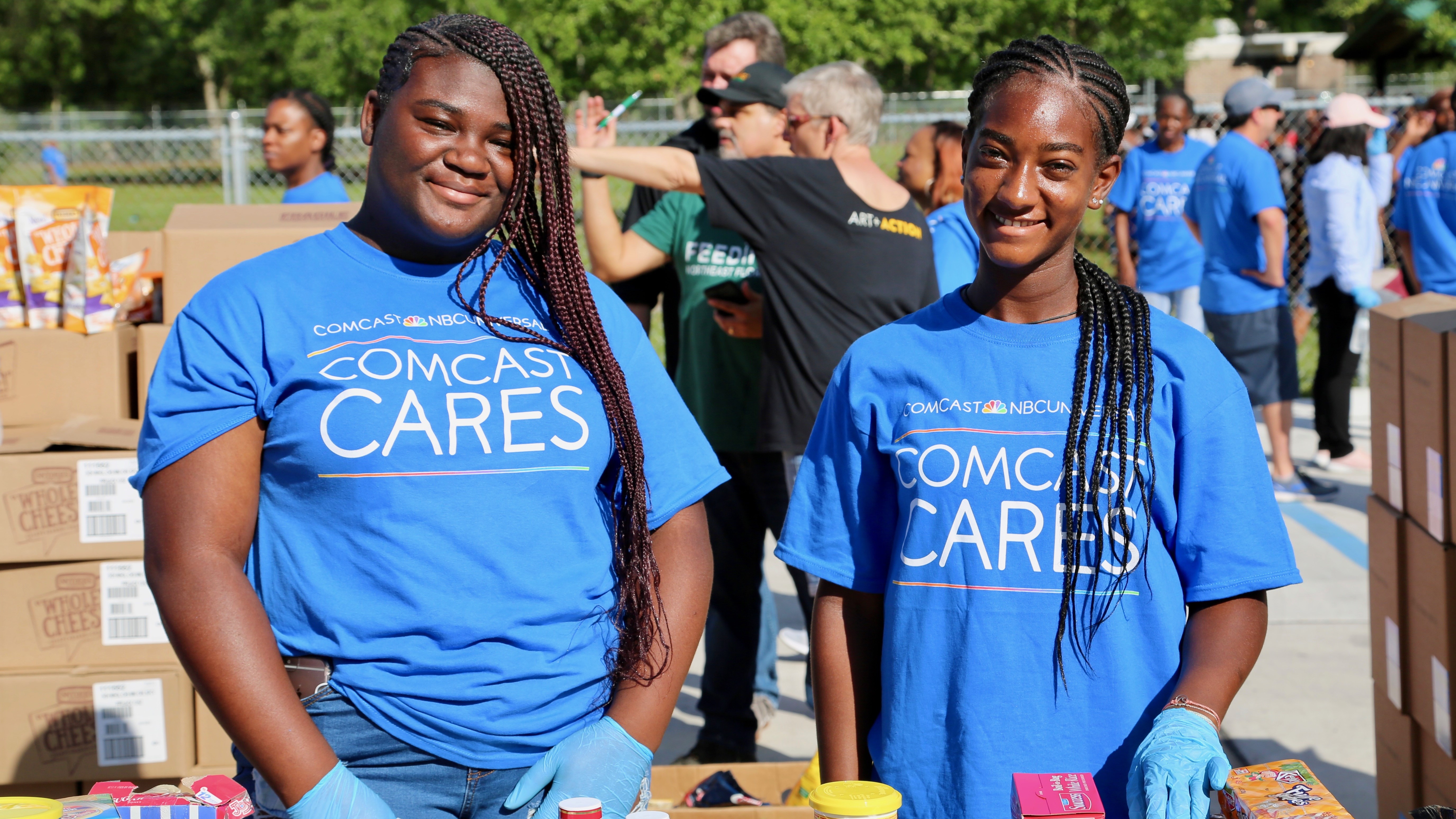 Comcast Cares Day volunteers prepare boxes of food for people in need.