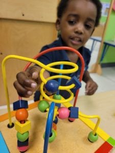 Young boy playing with toy.