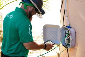 Technician working on wires in cable box