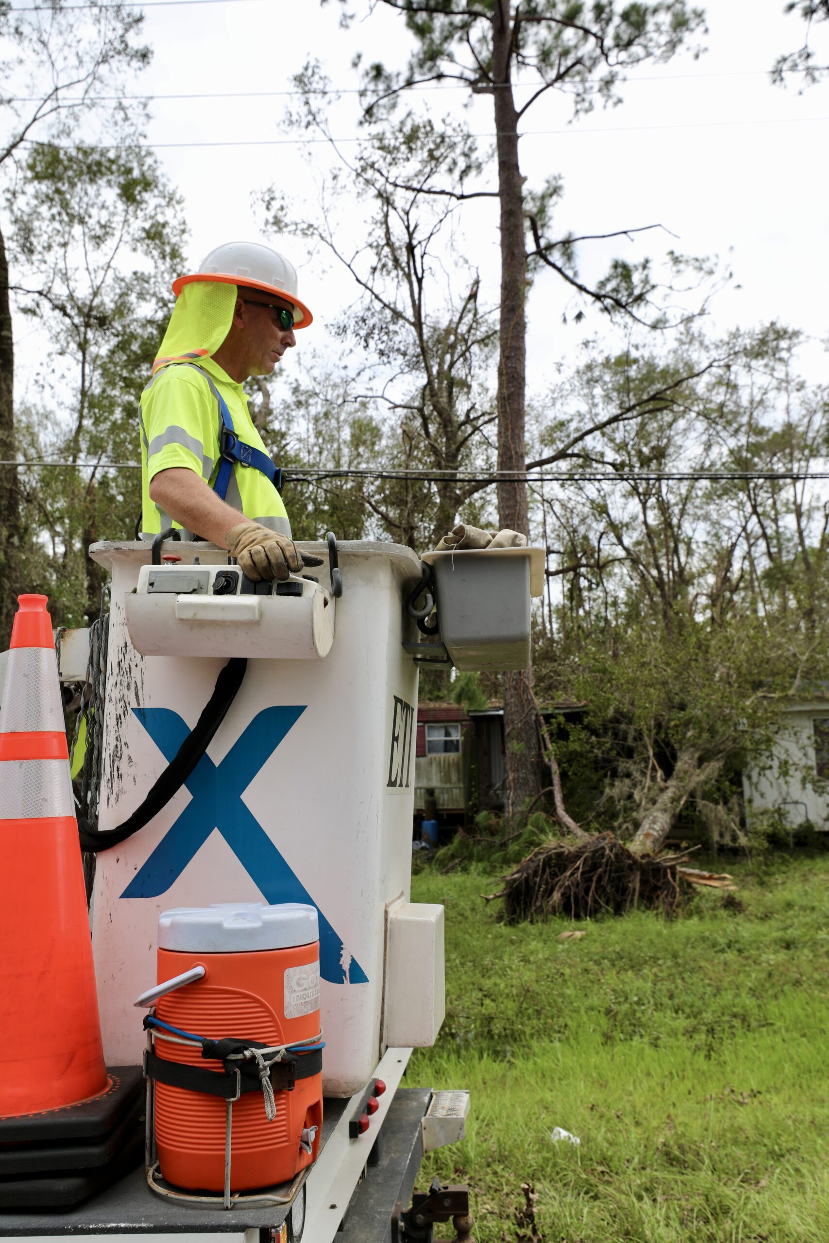 Xfinity technician repairing network post Idalia.