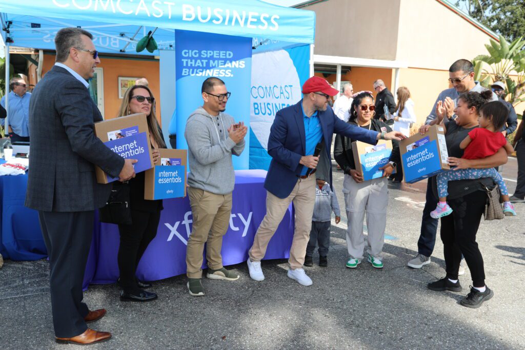 Comcast team distributing laptops in Arcadia