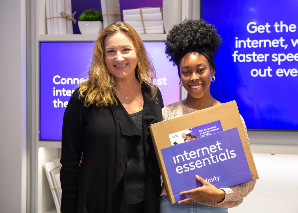 Women posing during laptop giveaway.