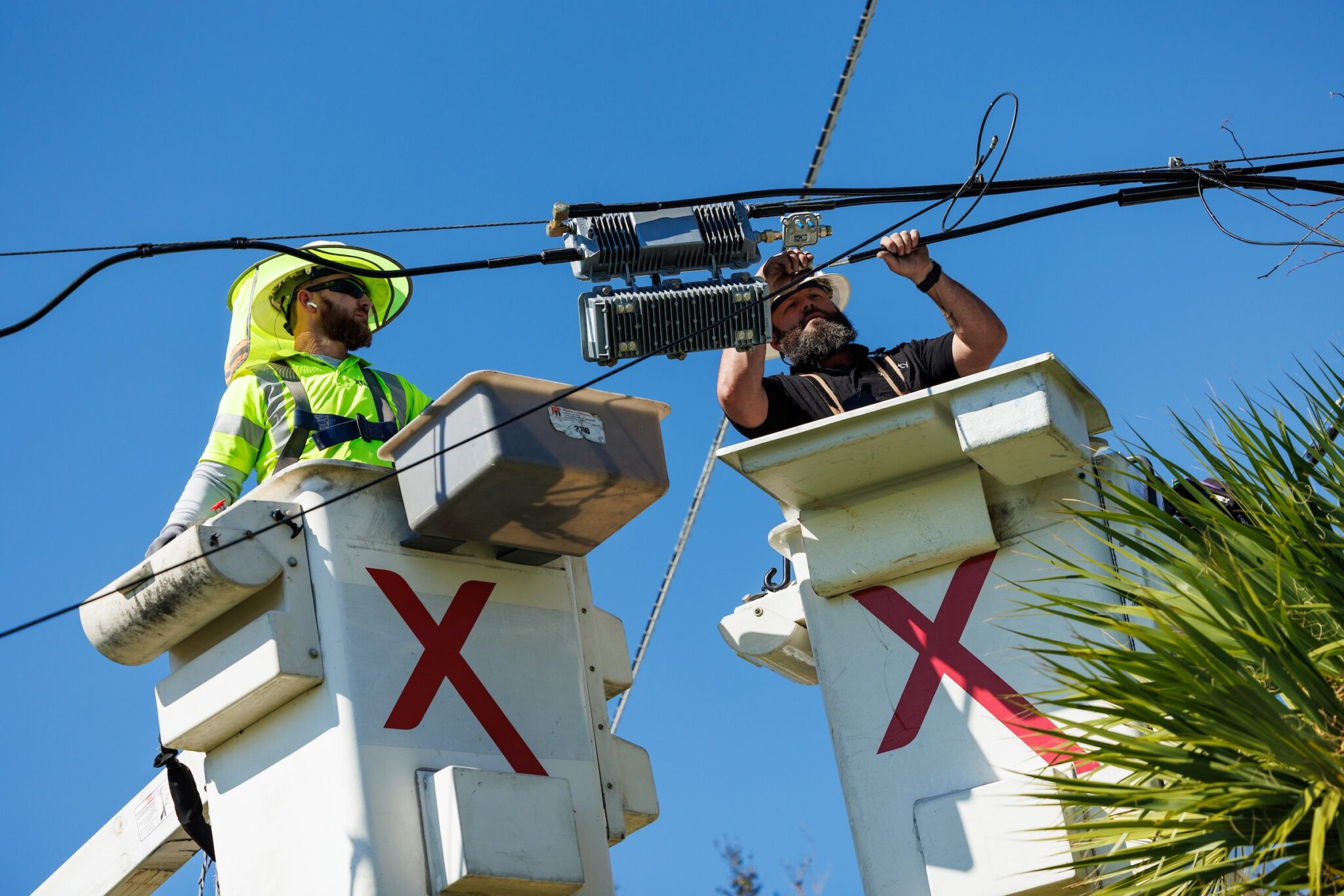 Men on a lift working.