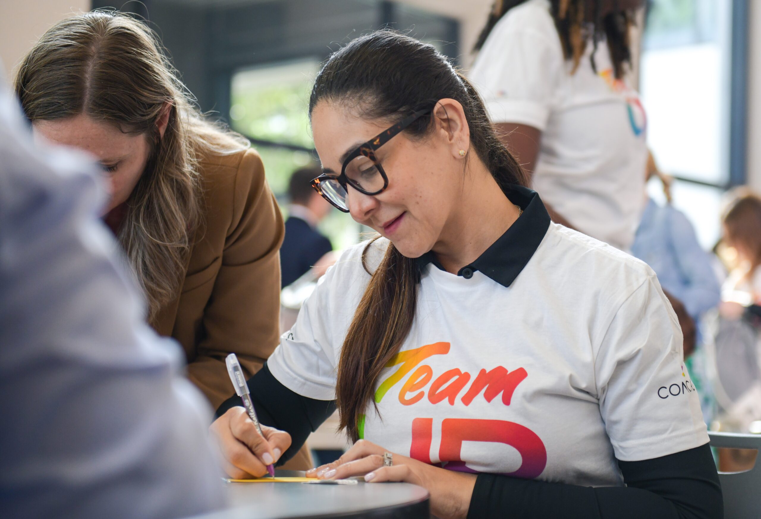 A woman is seen writing notes of encouragement.