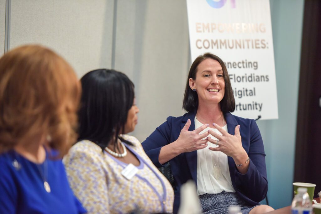 Woman speaking at roundtable discussion.