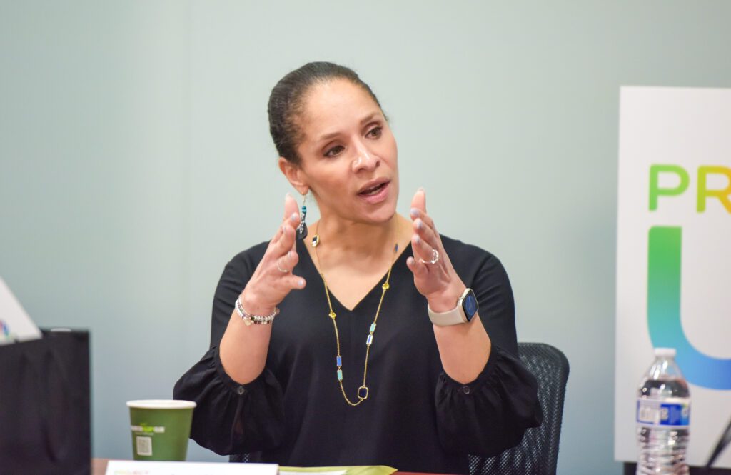 Woman talking at roundtable discussion.