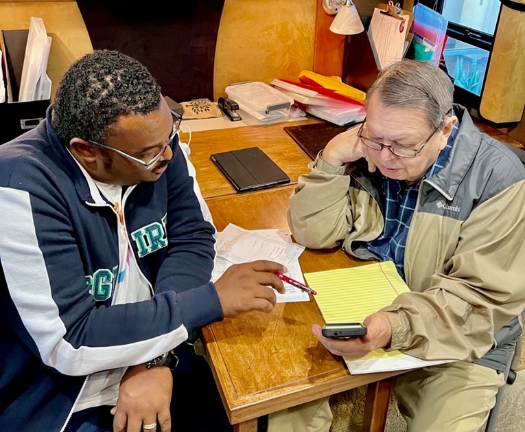 Young man teaching a senior citizen